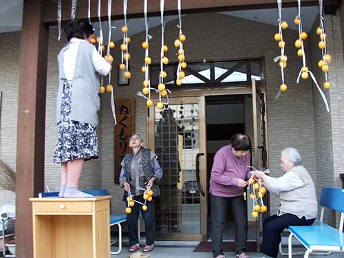 ▲入居者さまと一緒に干し柿づくりをして、親睦を深めています